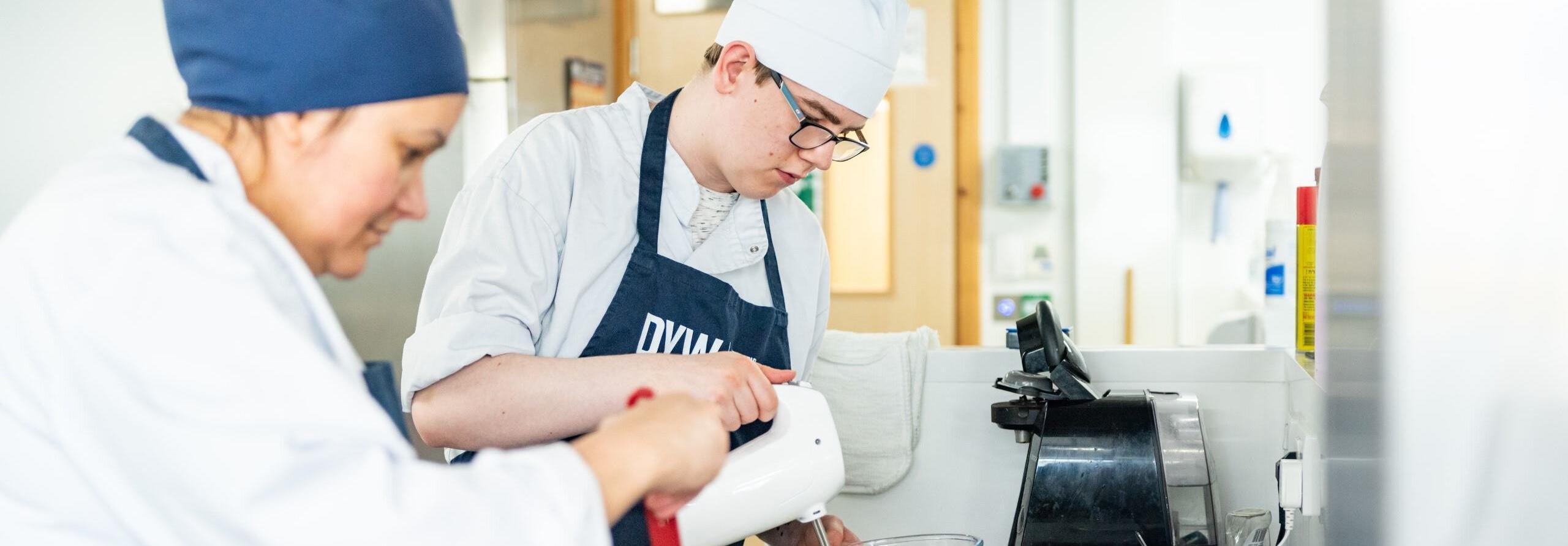 Two people cooking