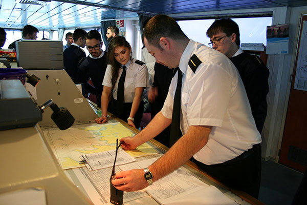 Merchant Navy Officer Cadet, Ann, on a visit to a ship with her fellow cadets