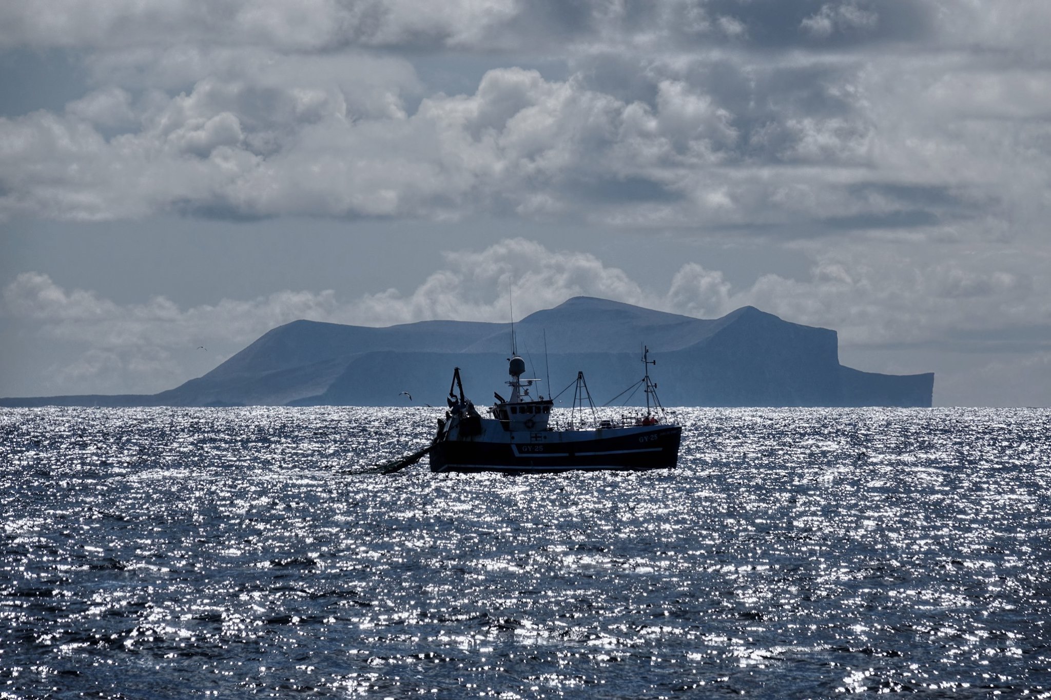 A fishing boat next to the island of foula